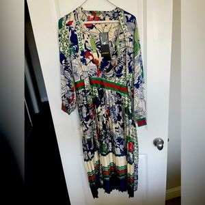 Silky dress. Tie around neck. Pleated skirt. Button up